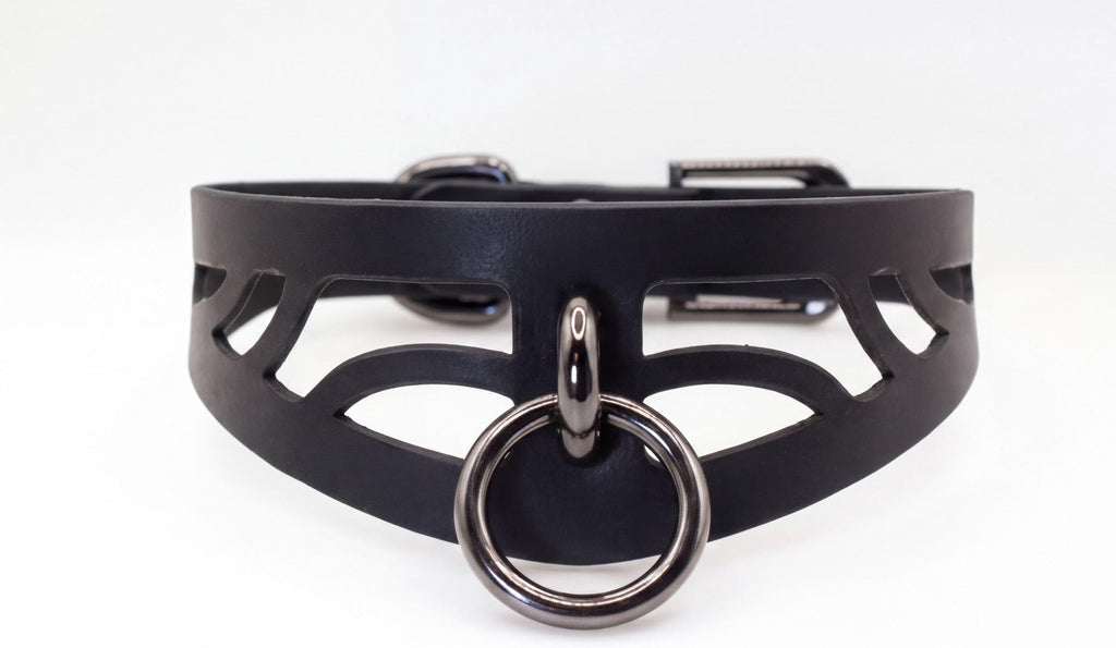 A black leather choker necklace with a metal ring and a metal buckle.