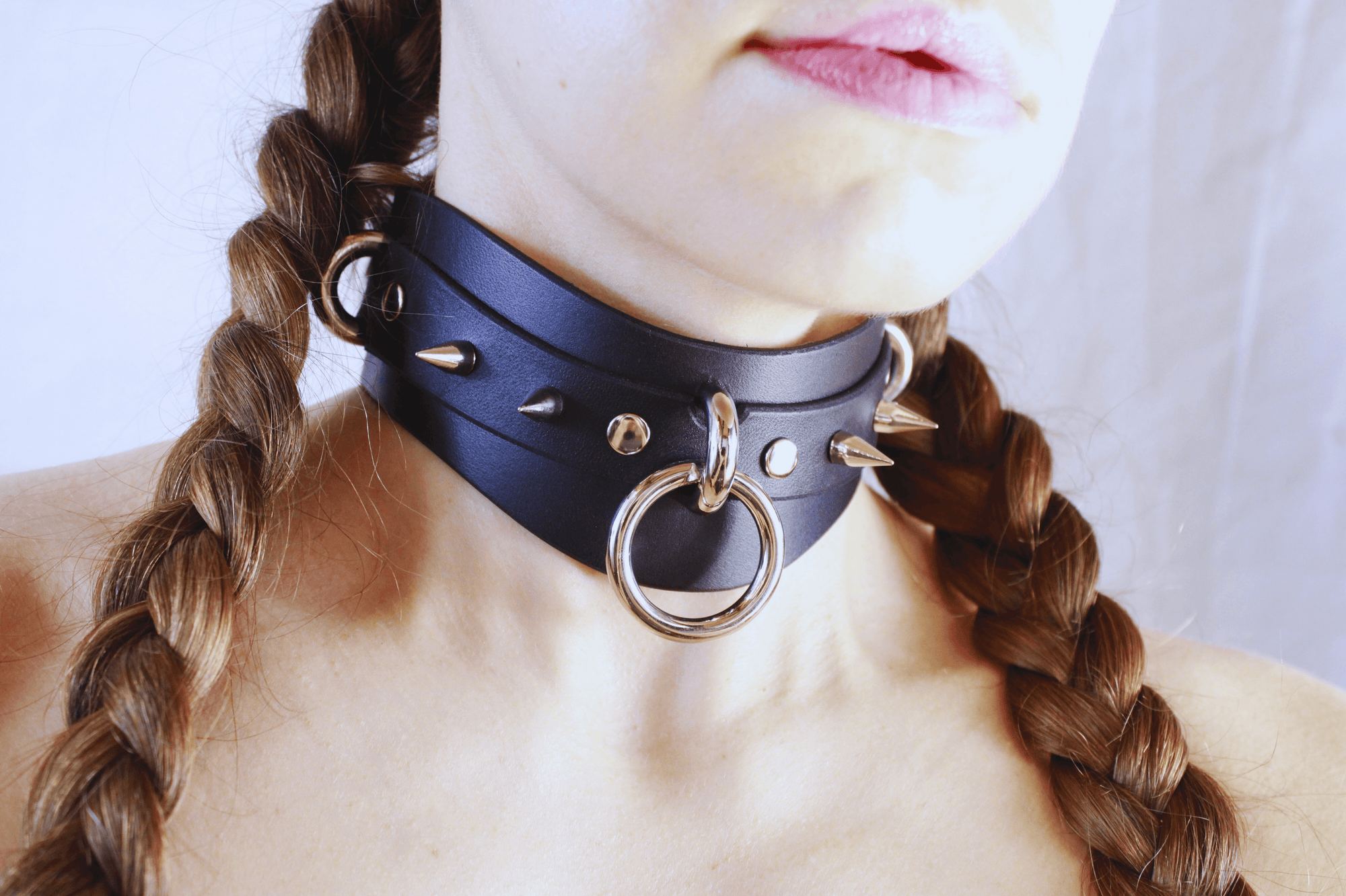 Spiked BDSM Collar worn on a model, showcasing a wide leather posture choker with spikes and a central ring.