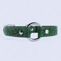 A green leather collar with a metal ring and decorative floral patterns.