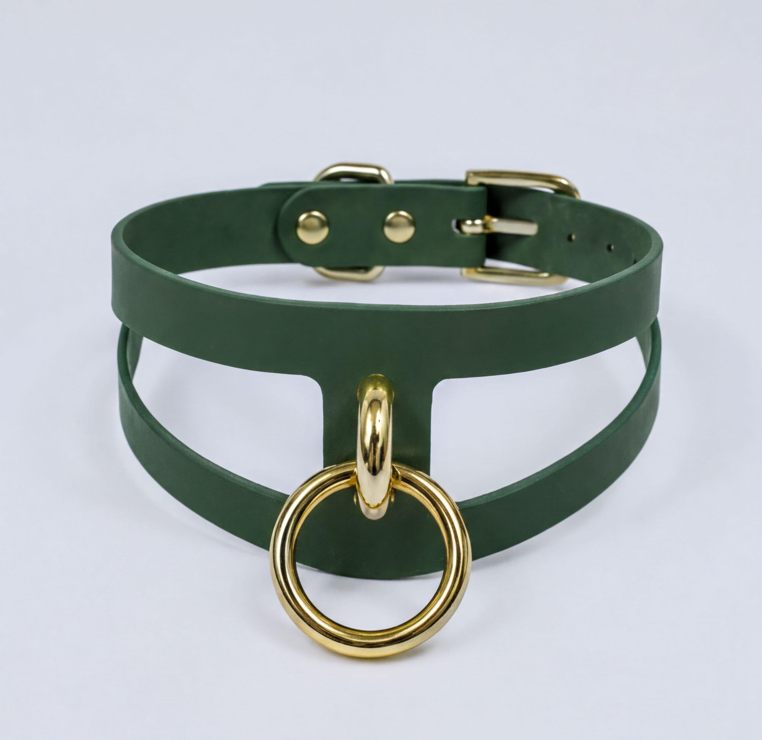 A green leather choker necklace with a gold-colored metal ring attached to it.