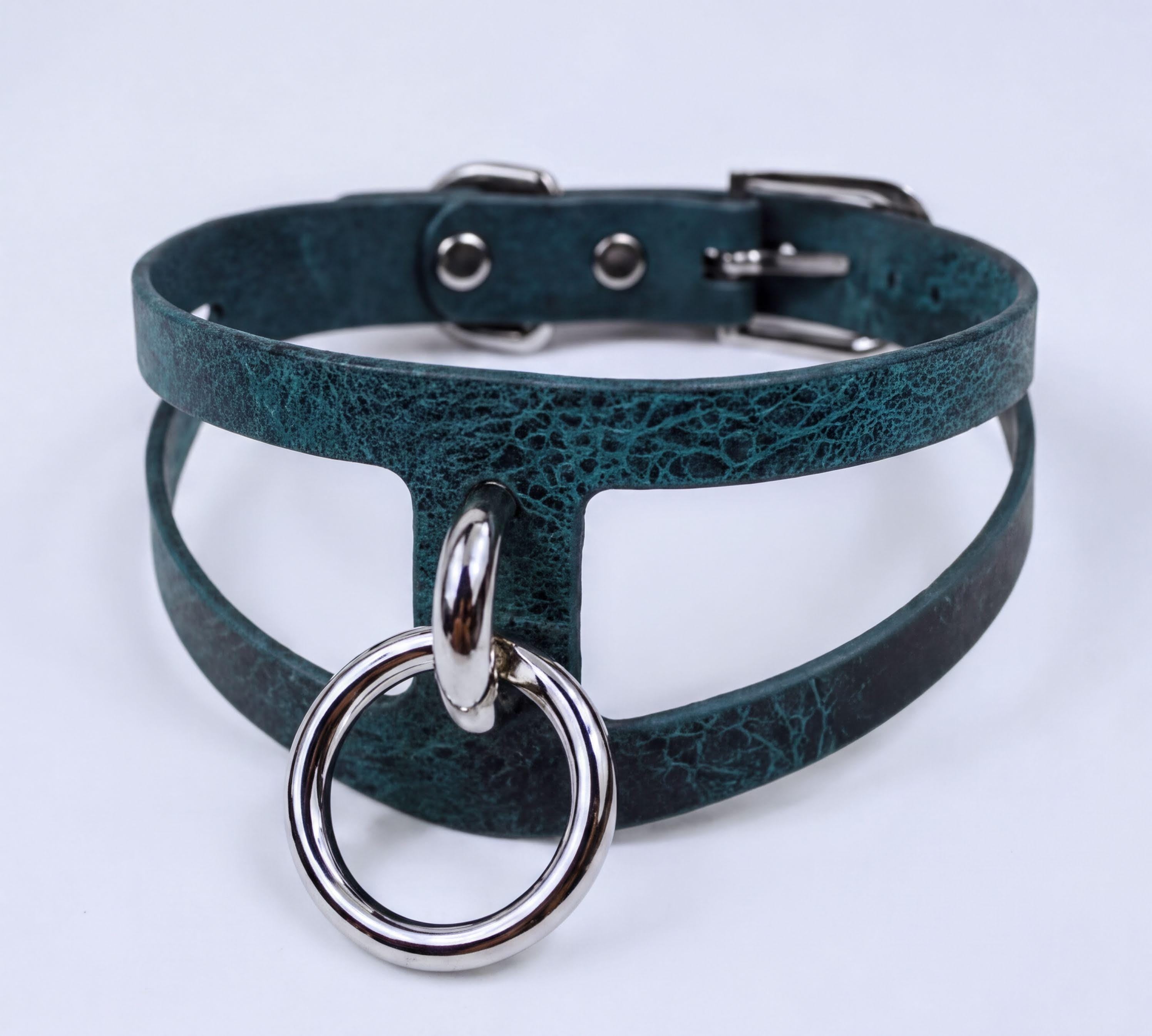 A dark green choker necklace with a silver ring and buckle.