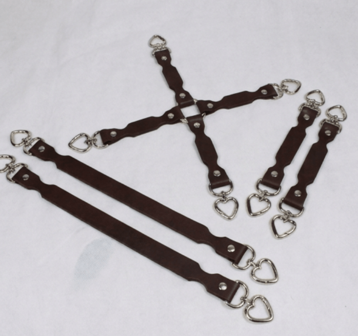 a collection of leather straps with metal heart-shaped buckles, arranged in various orientations.