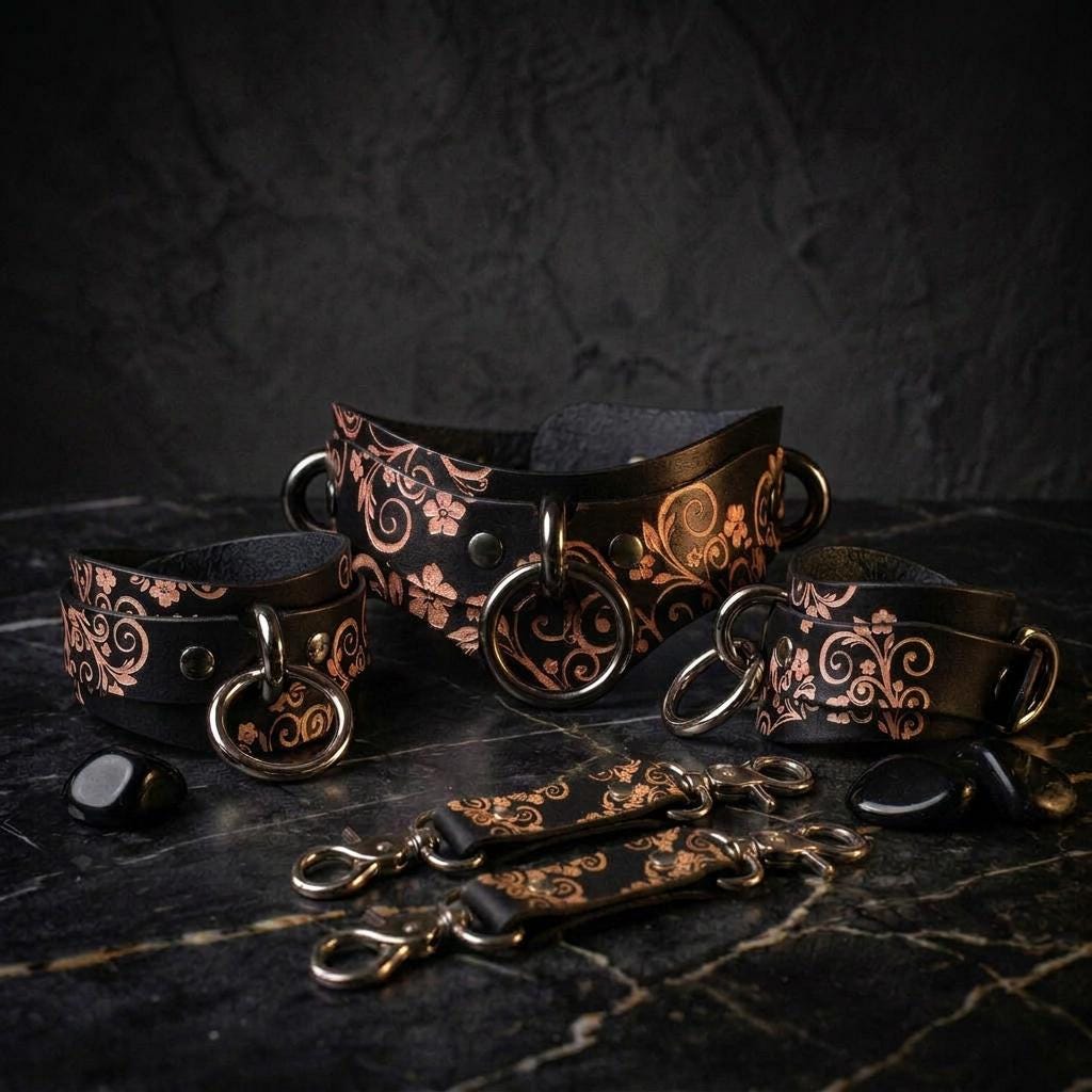 a collection of ornate leather straps and buckles, featuring intricate floral and scroll designs, arranged on a dark surface.