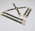 a collection of leather straps with gold-colored metal hardware, including heart-shaped buckles, arranged in various orientations.