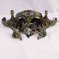 A pair of ornate leather straps with metal rings and buckles, likely used for decorative or functional purposes.