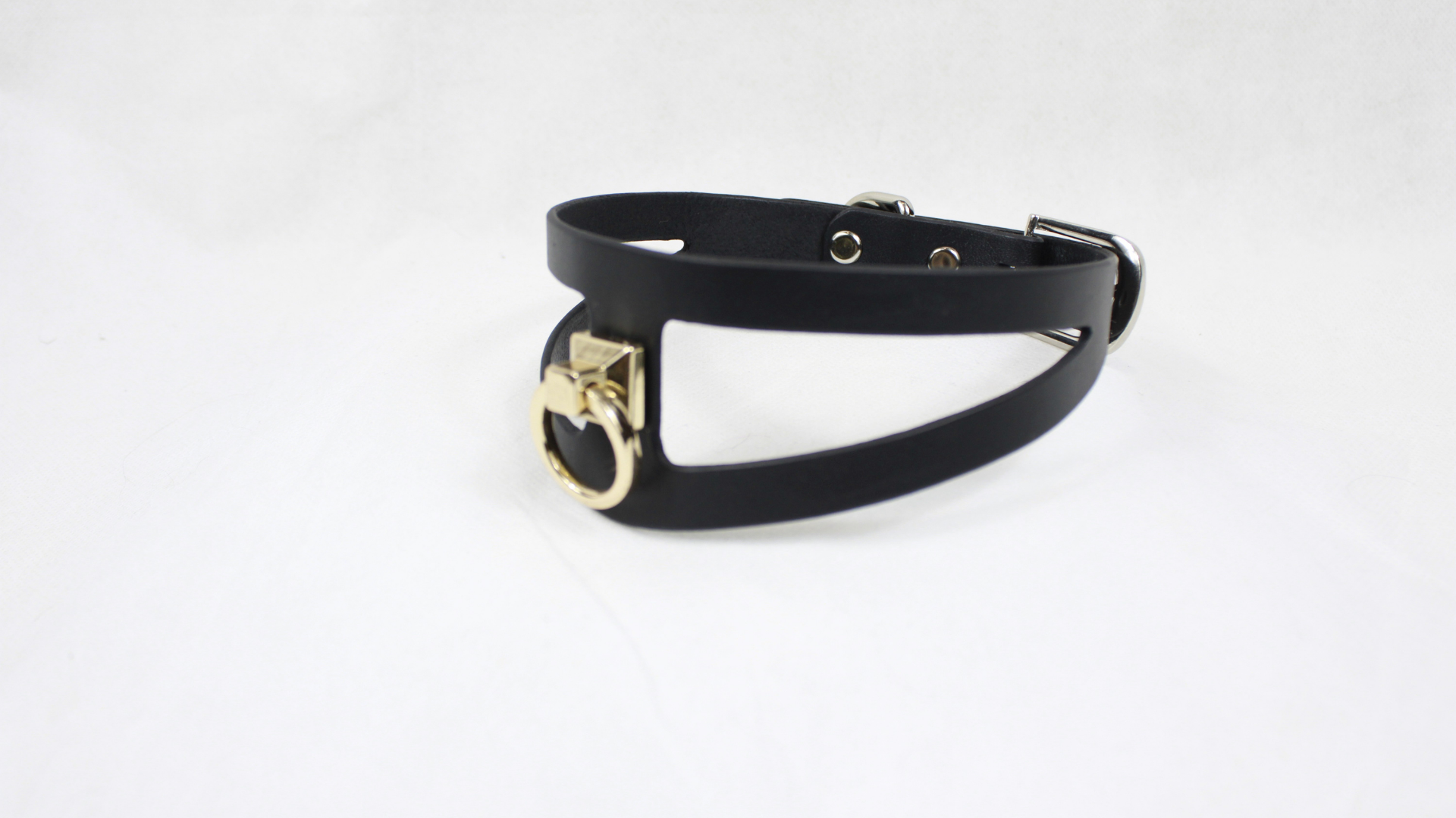 A black leather choker necklace with a gold-colored metal clasp.