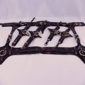 A collection of leather straps with metal rings and buckles, arranged in a decorative manner.