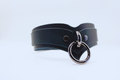 A black leather choker necklace with a silver ring and buckle.