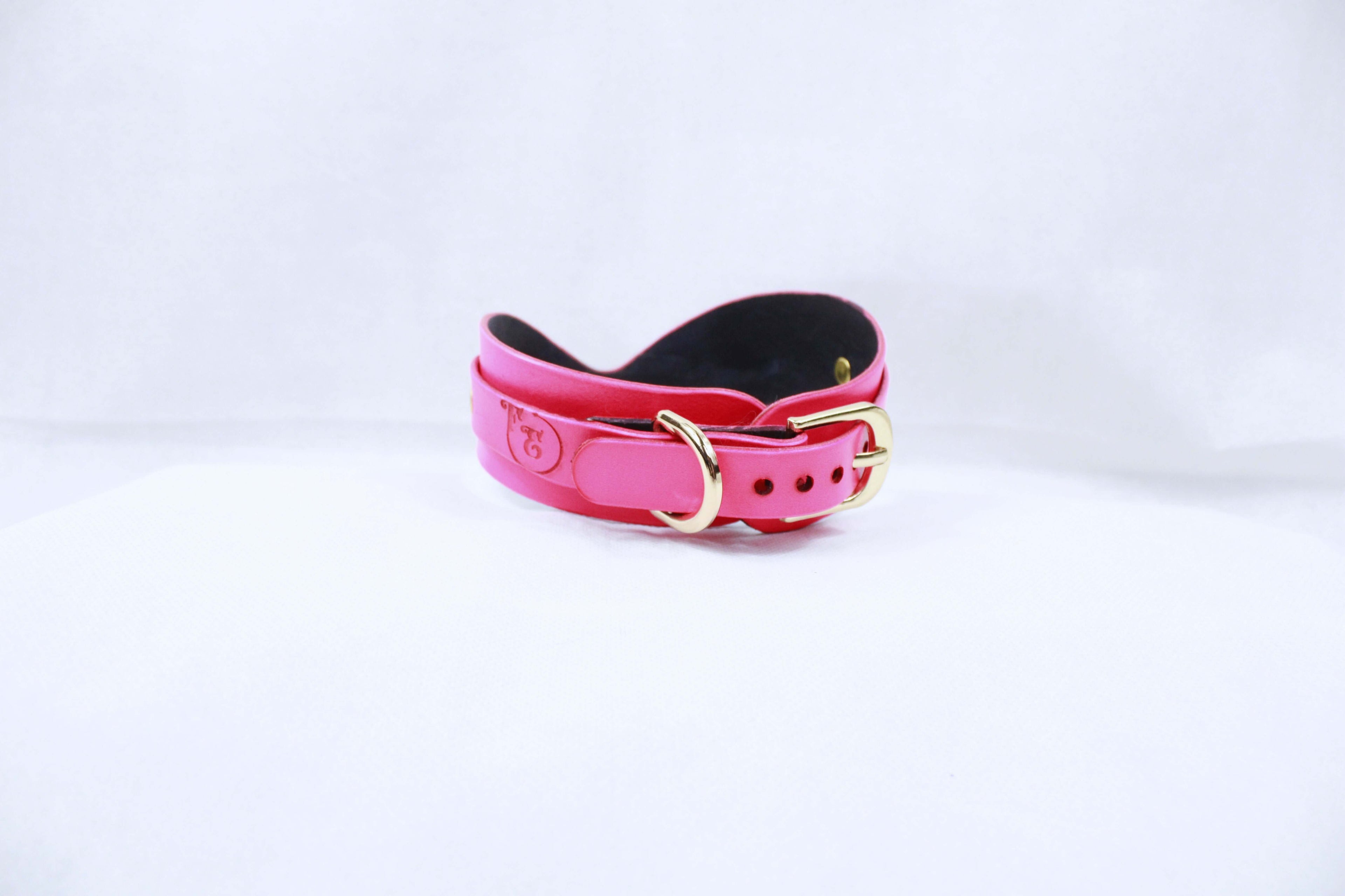 Elegant pink BDSM collar with gold hardware, perfect for submissive jewelry and bondage gear.
