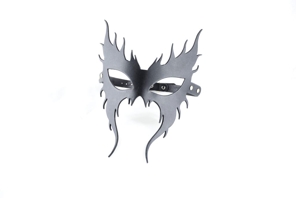 A black mask with a stylized design, resembling a mask or mask-like object.