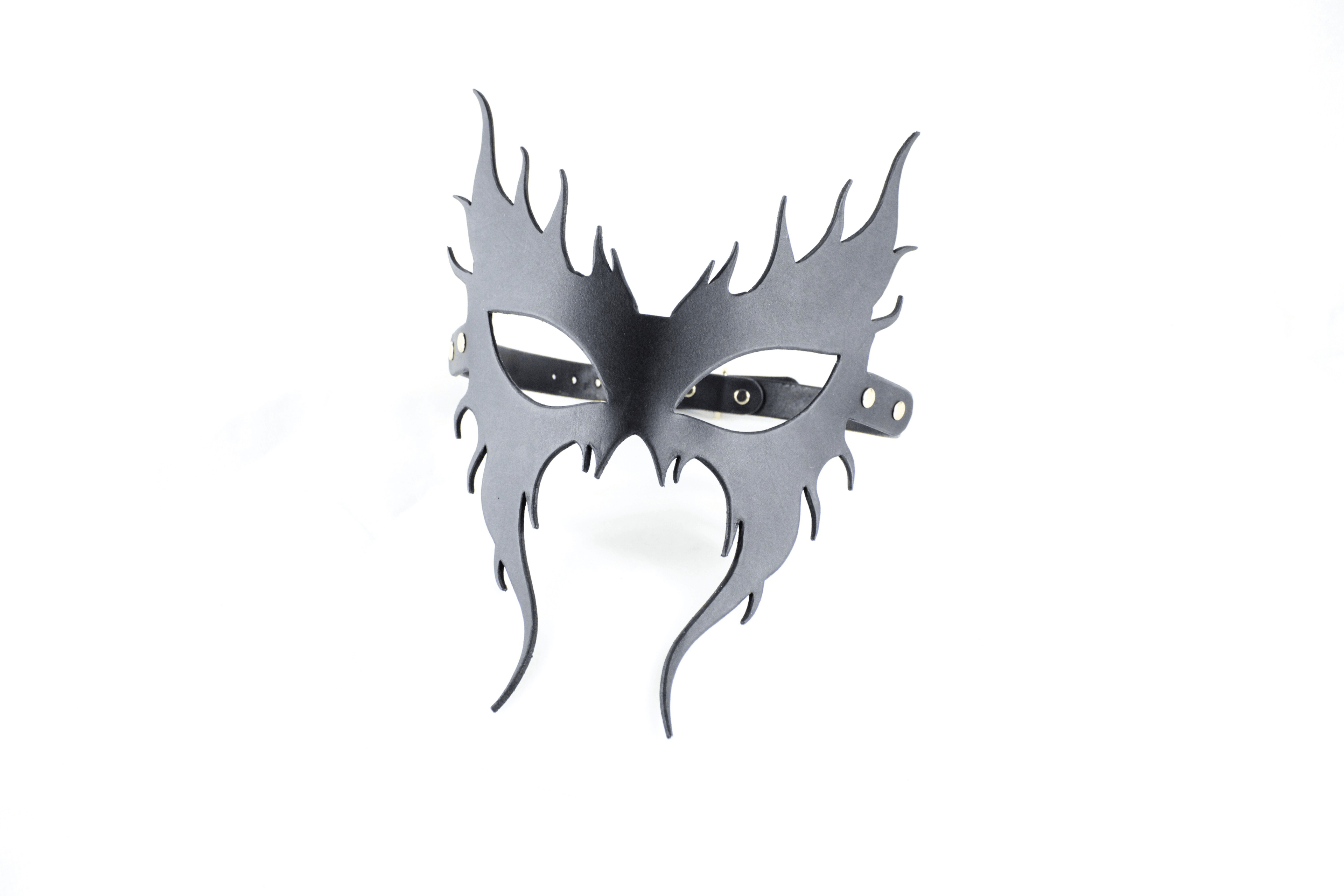 A black mask with a stylized design, resembling a mask or mask-like object.