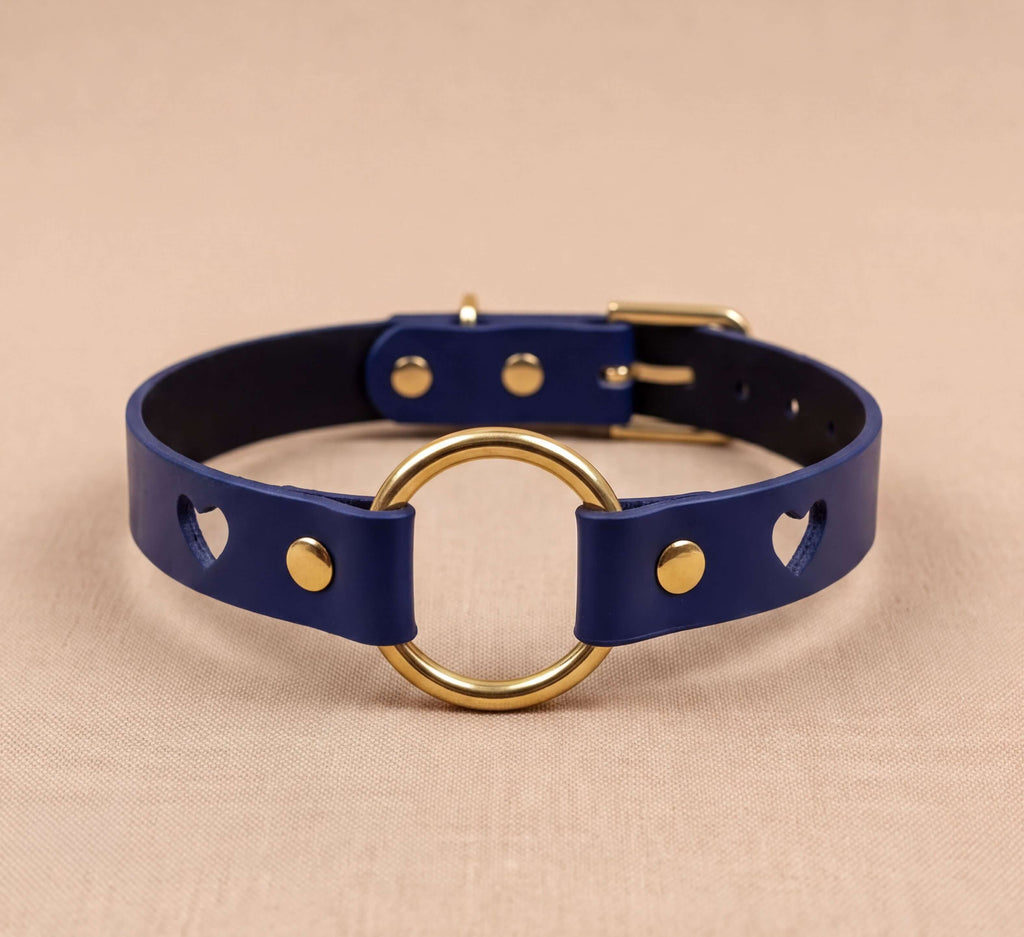 A blue leather choker necklace with a gold-colored ring and a black leather buckle.