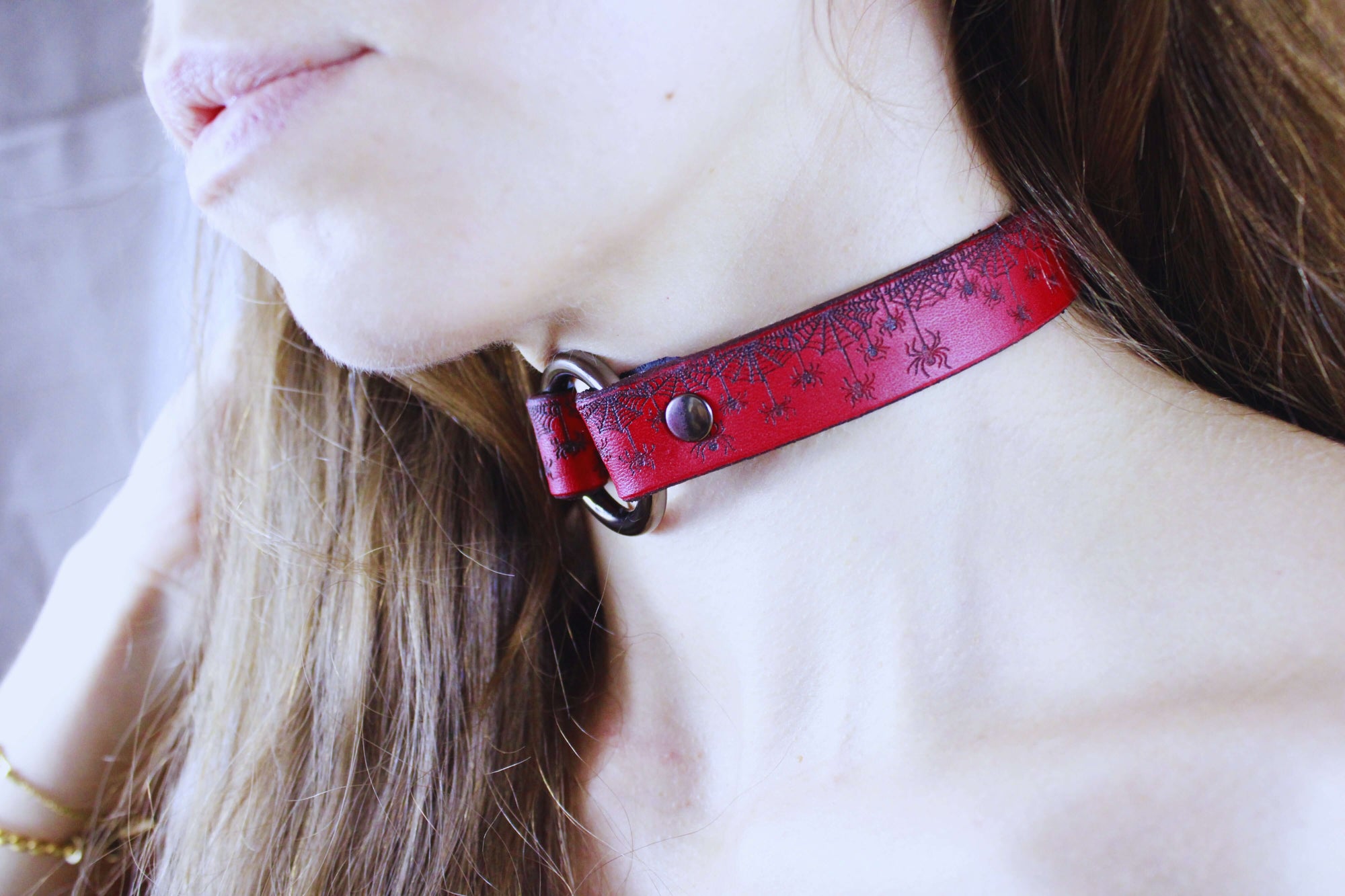 Red Spiderweb Submissive Collar in red leather with spiderweb design worn by model.
