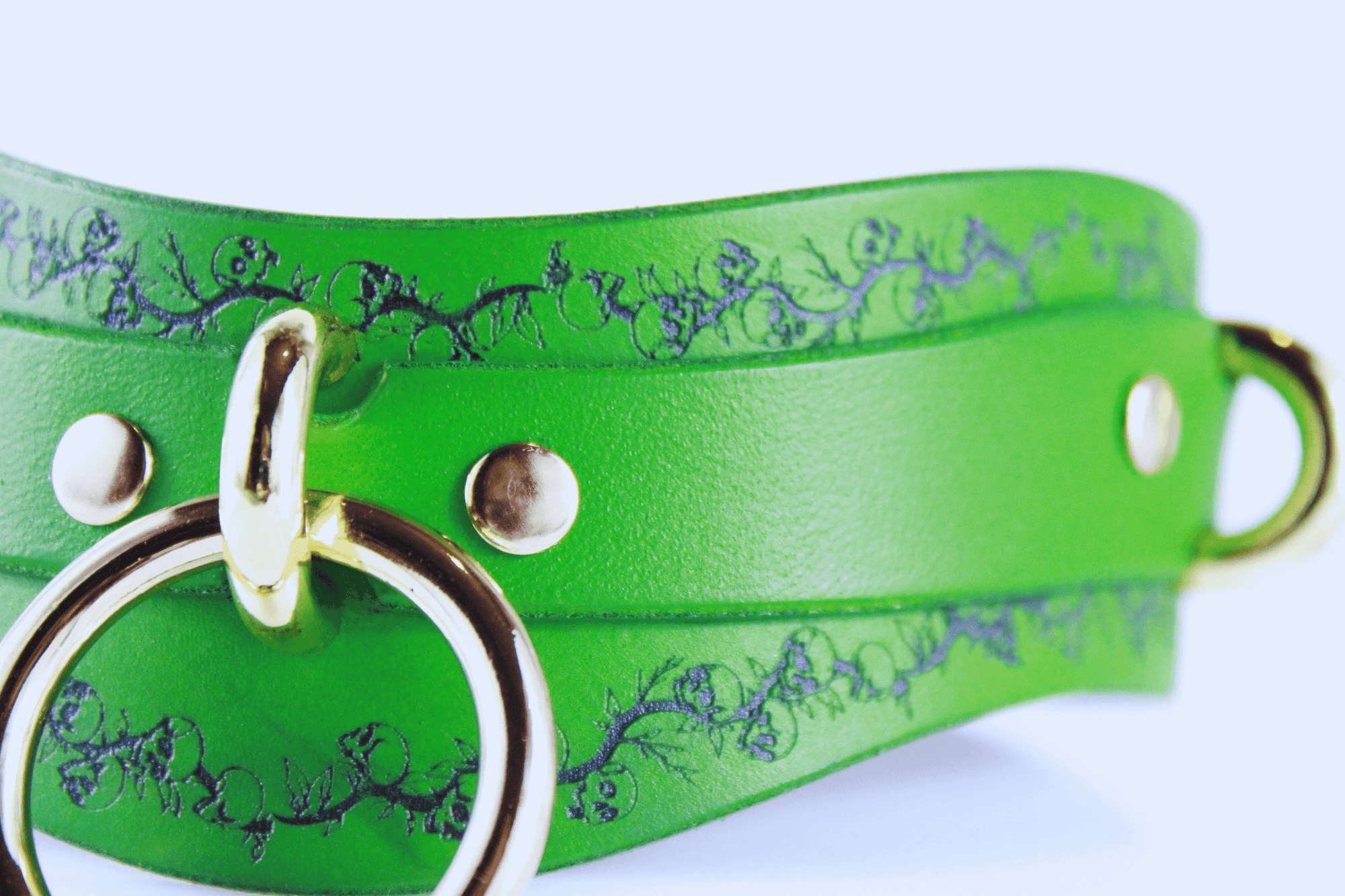 Skull Leather Choker with floral skull motif and gold hardware on vibrant green leather strap.