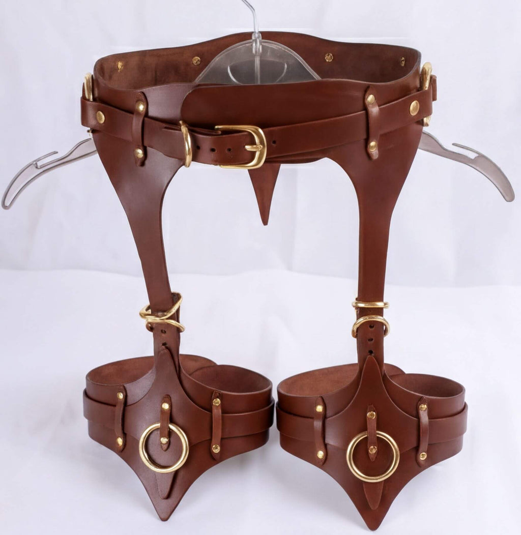 A pair of brown leather straps with gold hardware, designed to be worn as a corset or waist corset.