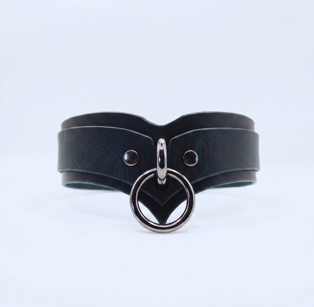 A black leather choker necklace with a silver metal ring and two metal studs on the front.