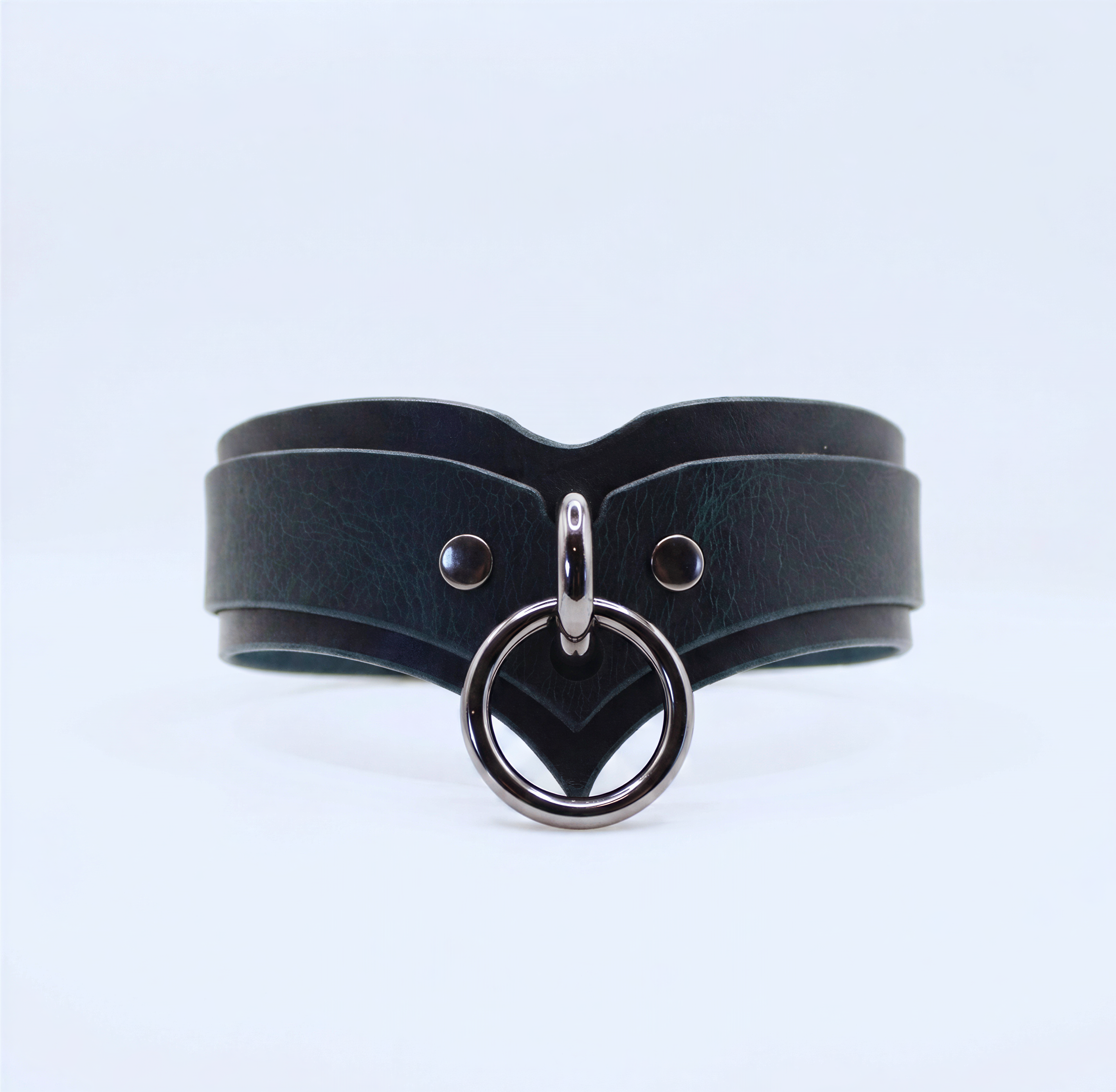 A black leather choker necklace with a silver metal ring and two metal studs on the front.