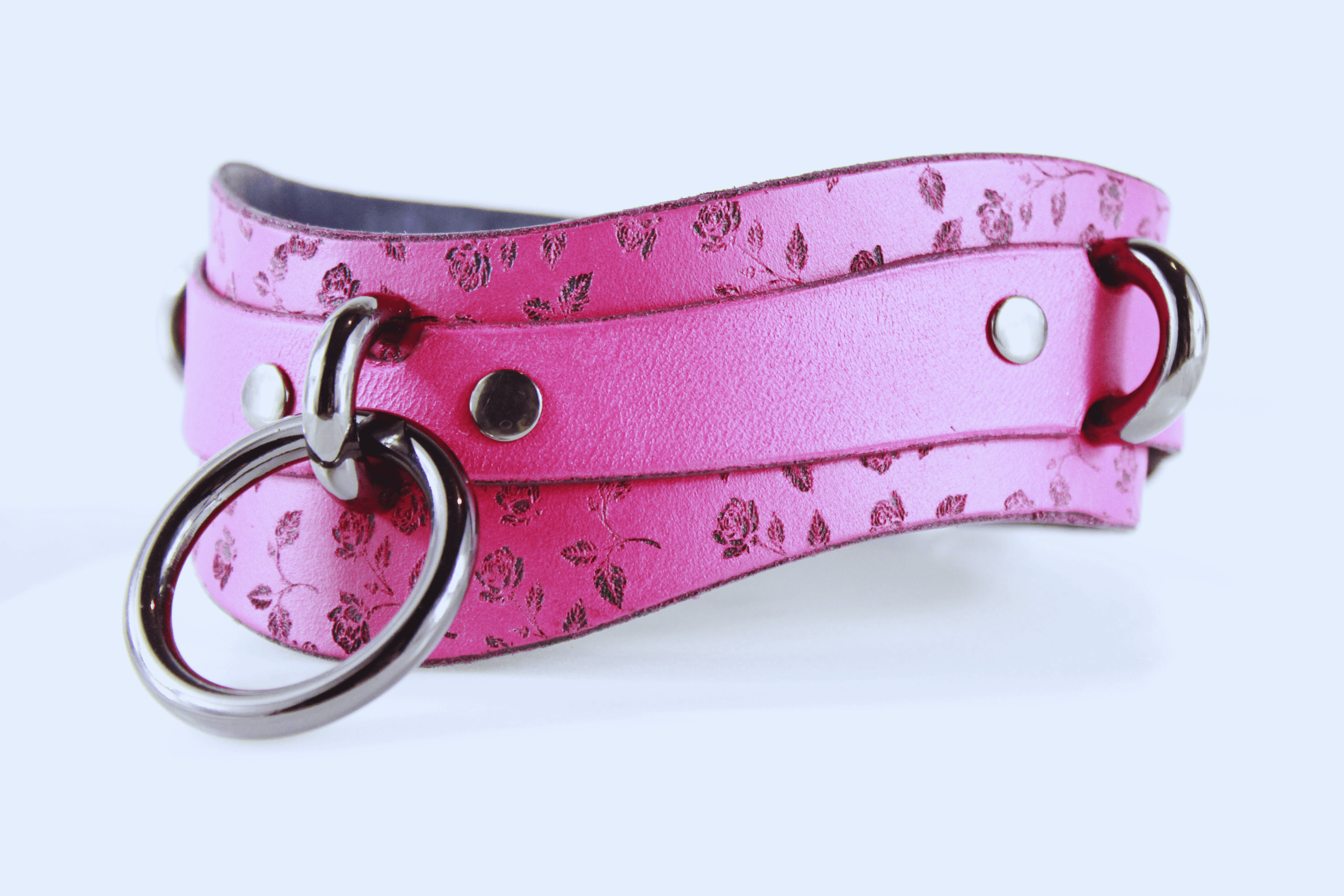 Rose Leather Submissive Collar in soft pink leather with floral design and metal accents, perfect for discreet daily wear.