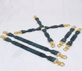 A group of dark green leather straps with gold metal clasps and buckles, arranged in a diamond-like pattern on a white background.