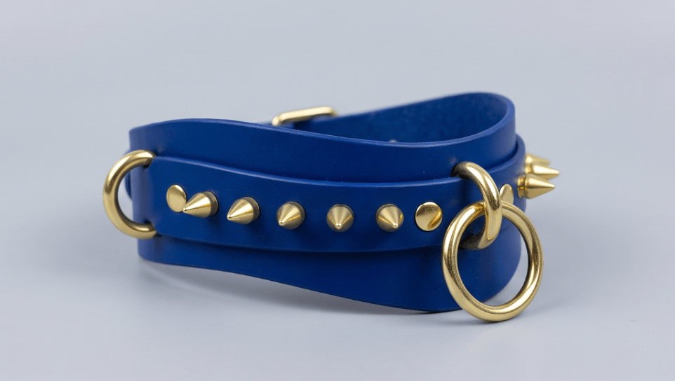 A blue leather choker bracelet with gold studs and a ring on the front.