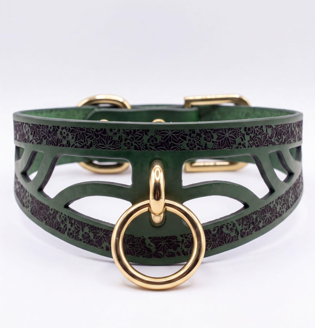 A green leather choker collar with a gold ring and buckle.