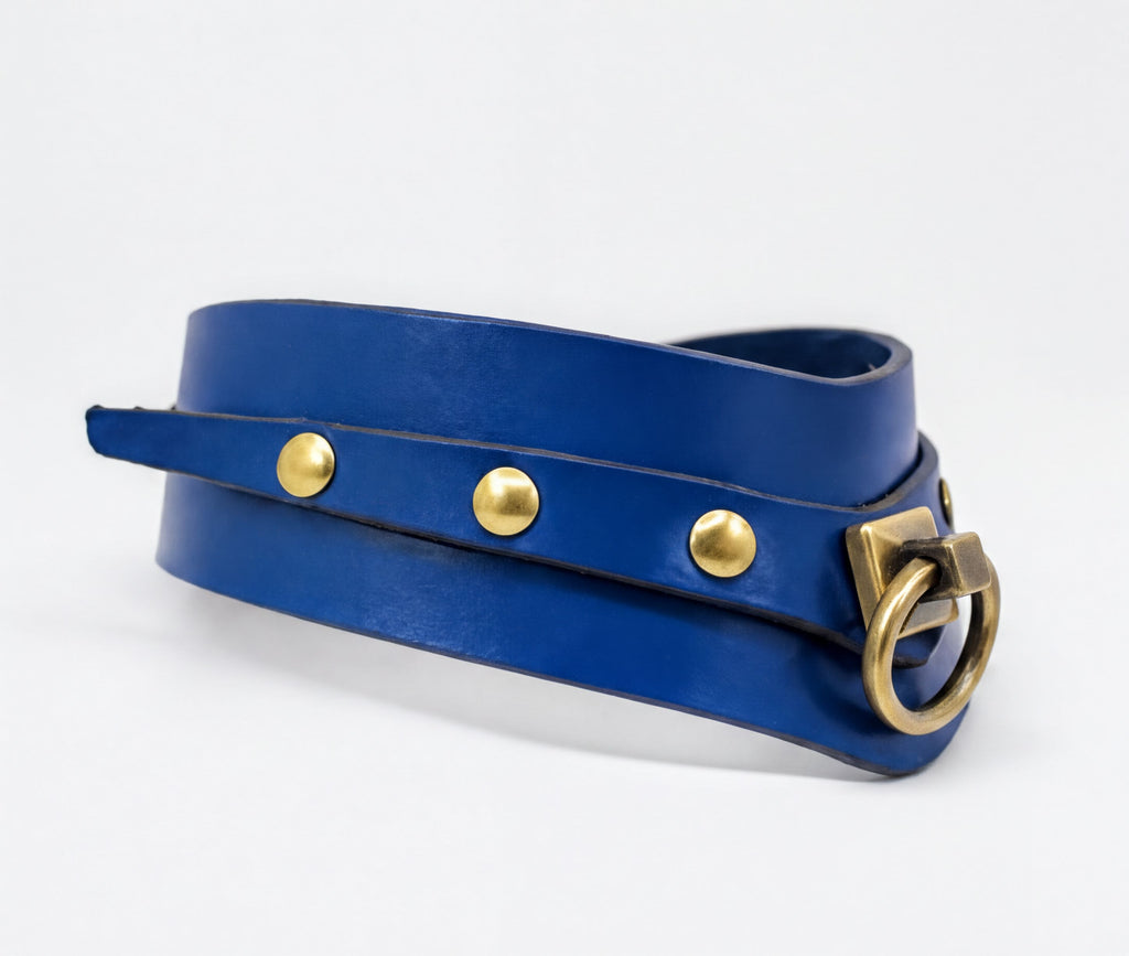A blue leather choker necklace with gold-colored metal studs and a metal clasp.