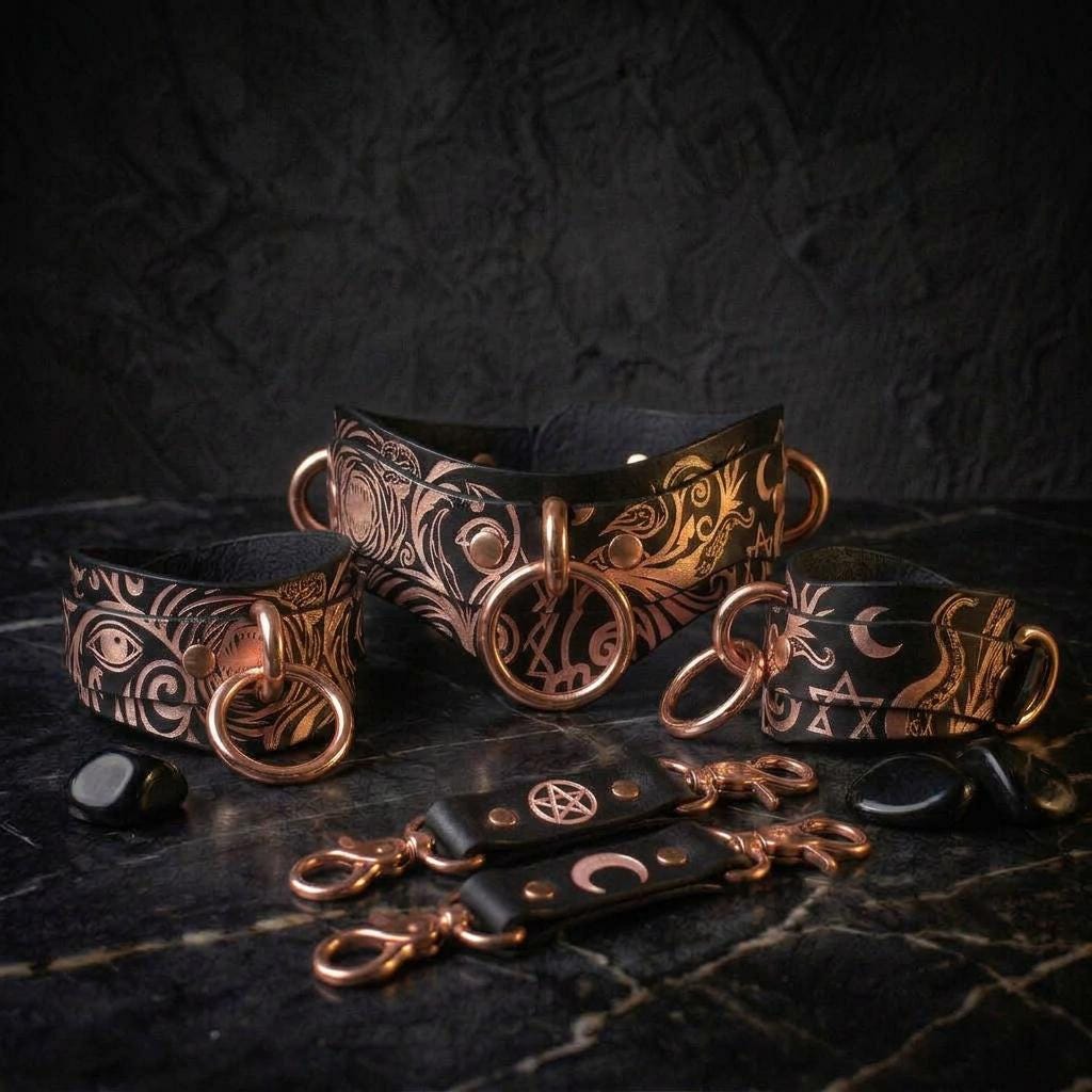 a collection of ornate leather accessories, including collars, cuffs, and straps, with intricate designs and metallic accents.