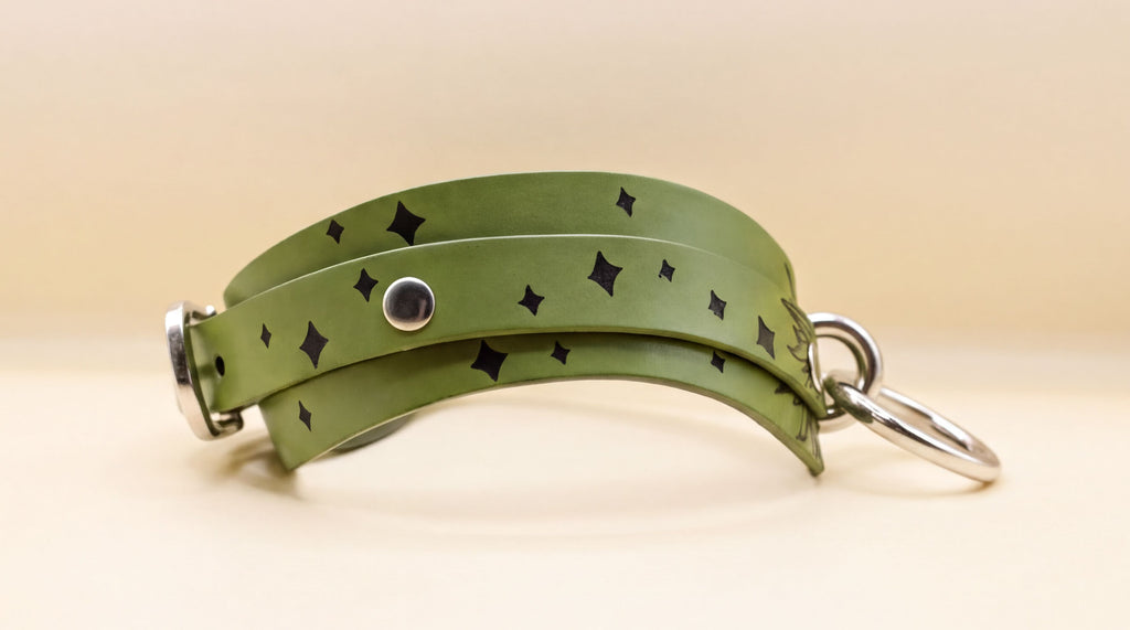 A green leather choker necklace with black diamond-shaped embellishments on the surface.