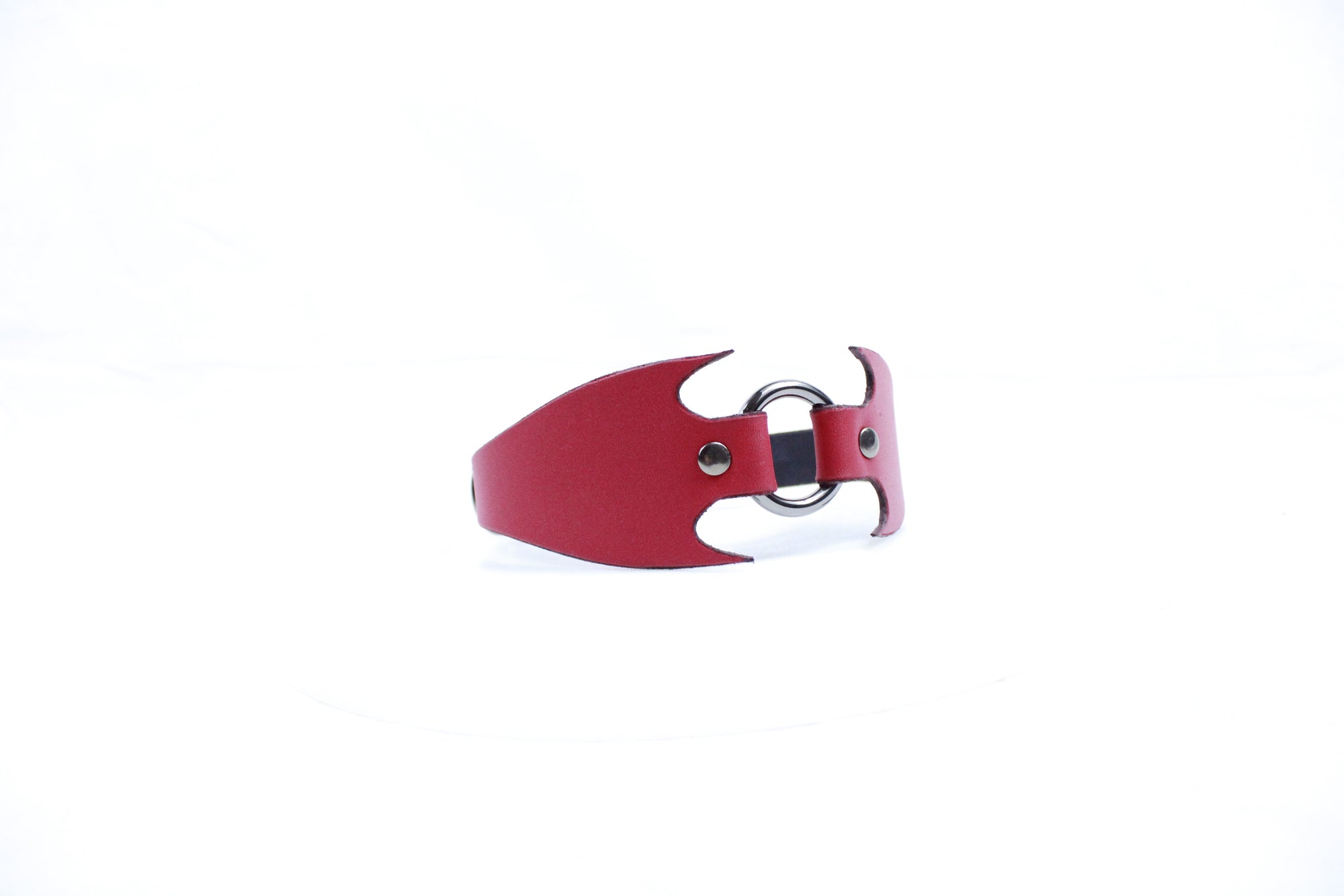 A red leather strap with a metal buckle is shown against a white background.