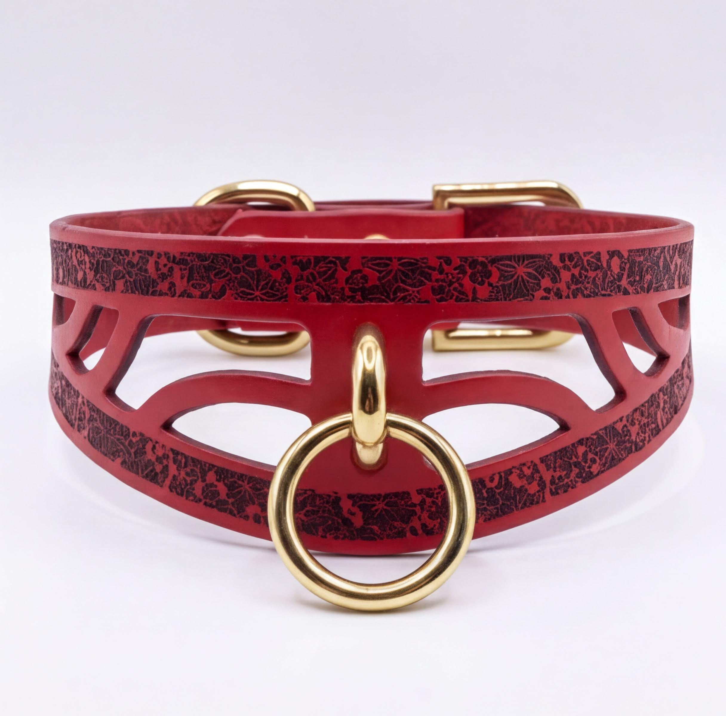 A red leather choker collar with a gold ring and buckle.