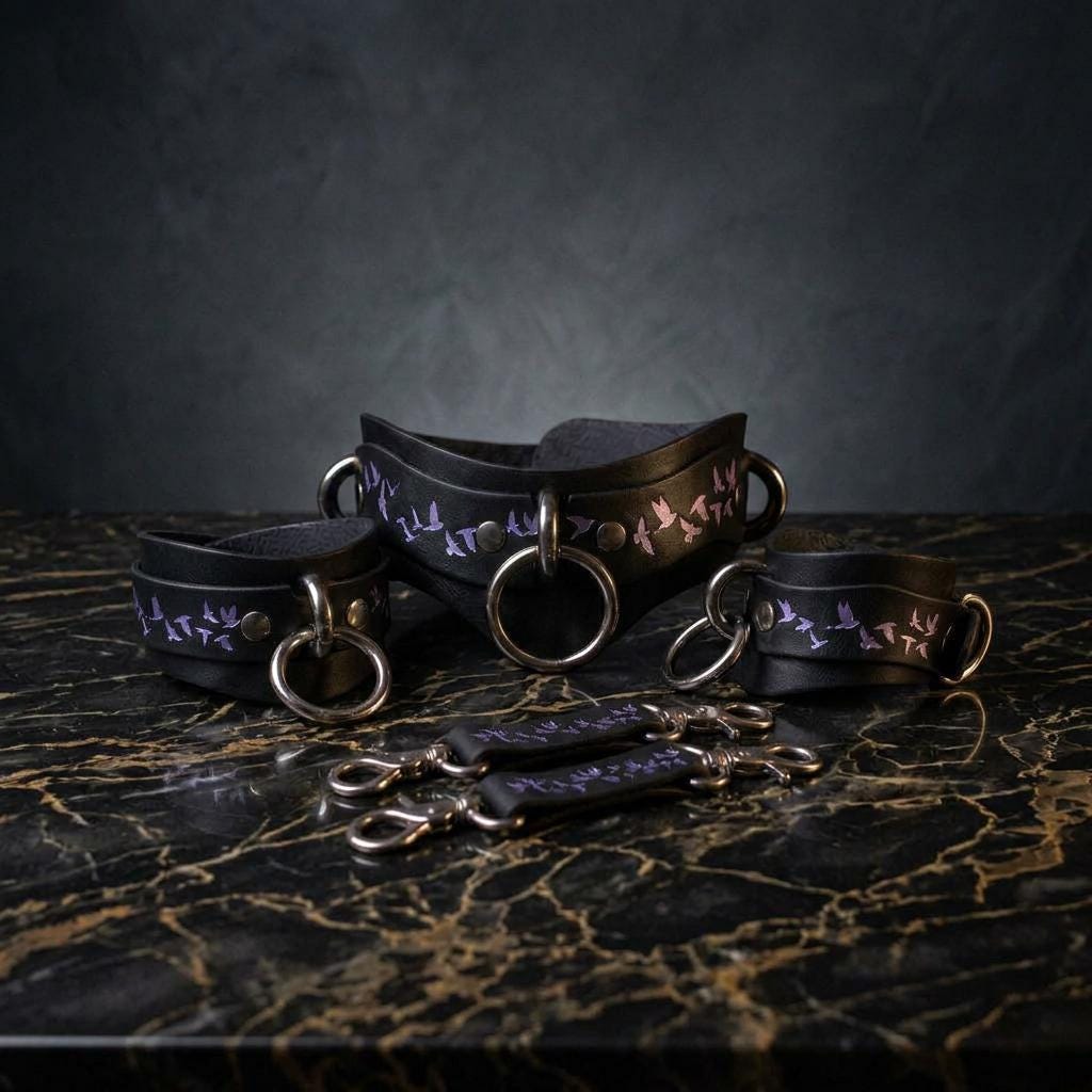 a set of black leather choker necklaces with purple floral designs, arranged on a marble surface.