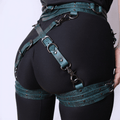A close-up view of a person wearing a black outfit with a green leather strap across the waist.