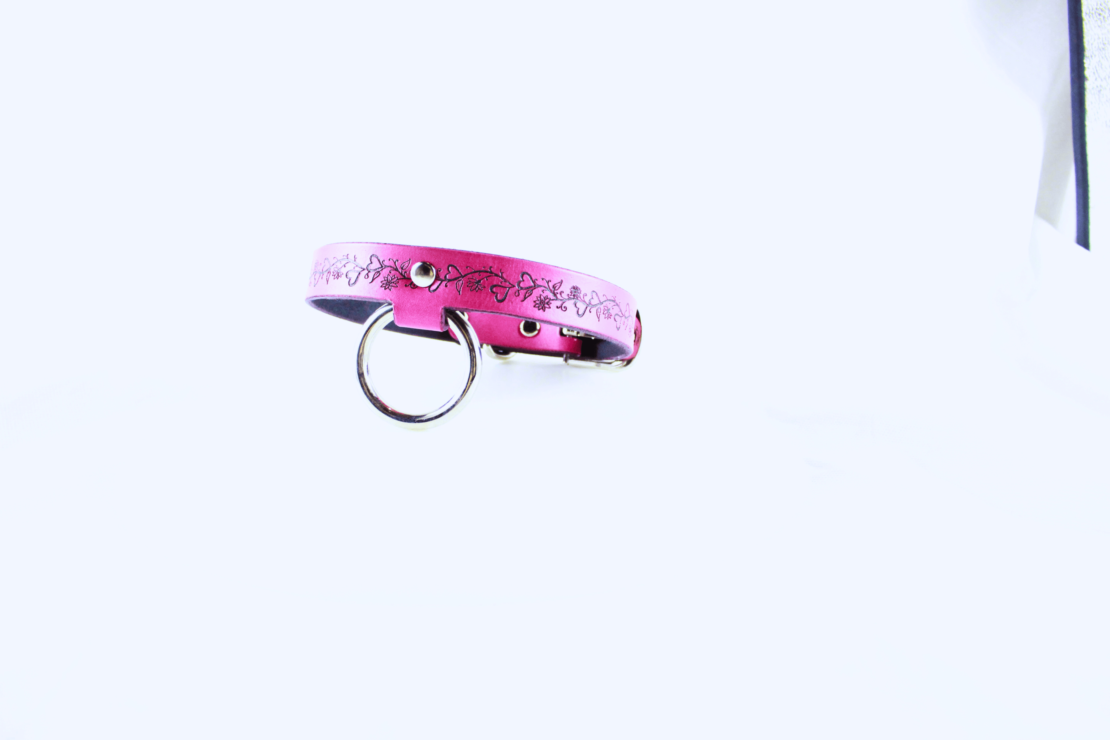 Pink Leather Fetish Collar featuring delicate designs and a metal ring for connection and trust.