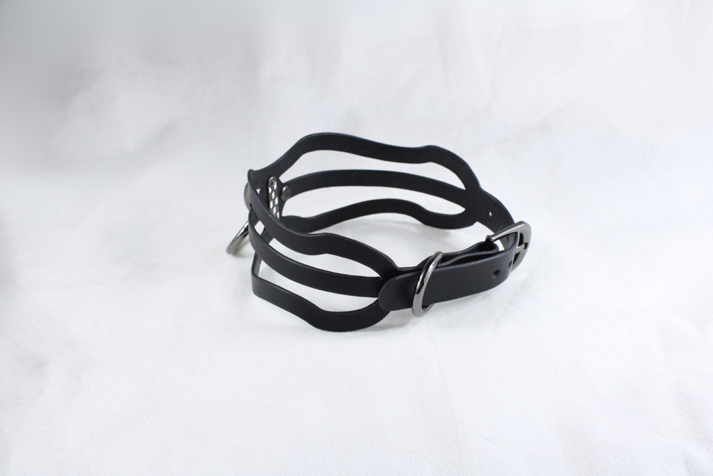 A black leather choker necklace with a unique, wavy design.