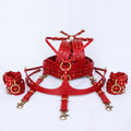 A set of red leather restraints or restraints with gold-colored metal studs, arranged on a white background.
