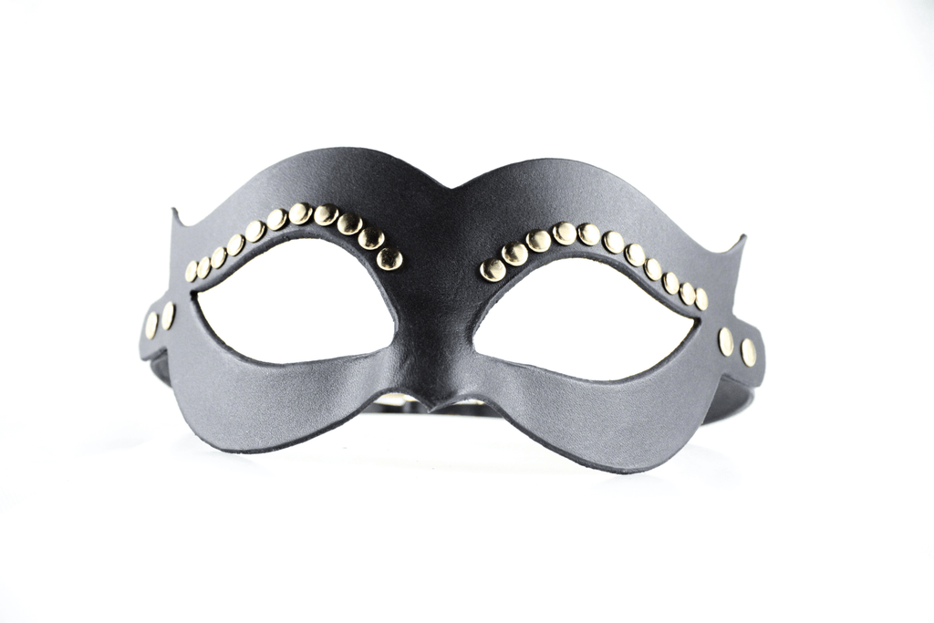A black leather mask with gold studs on the sides.