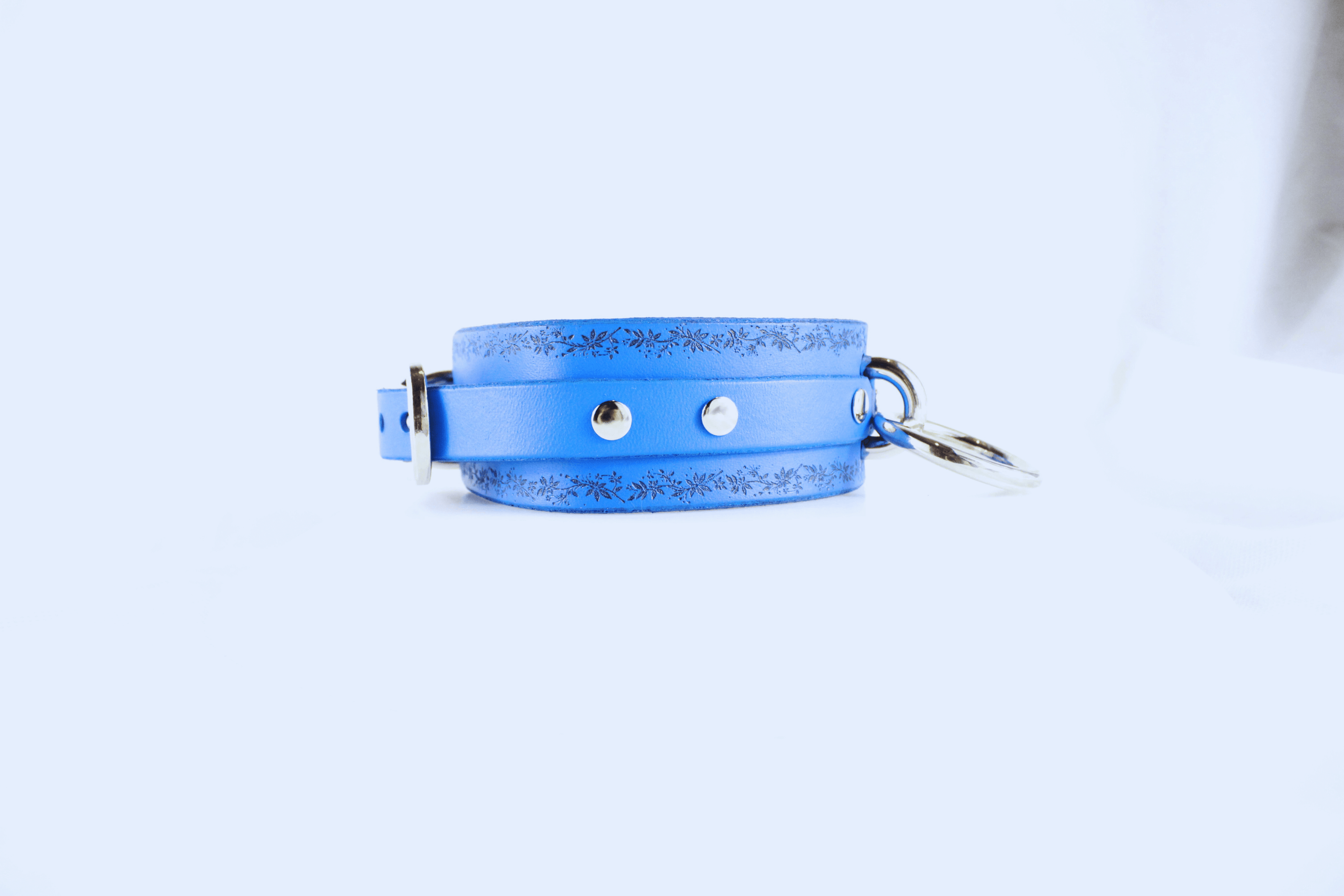 Floral Vine Leather Choker in blue with silver studs and O-ring, showcasing delicate floral vine motif.