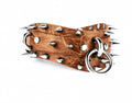 A leather belt with spikes protruding from it, and a metal ring attached to the belt.