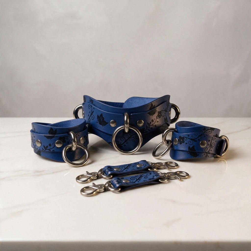 A set of blue leather straps with metal rings and buckles, arranged on a white marble surface.