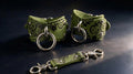 a pair of green leather straps with metal rings and a matching clasp, arranged on a dark surface.