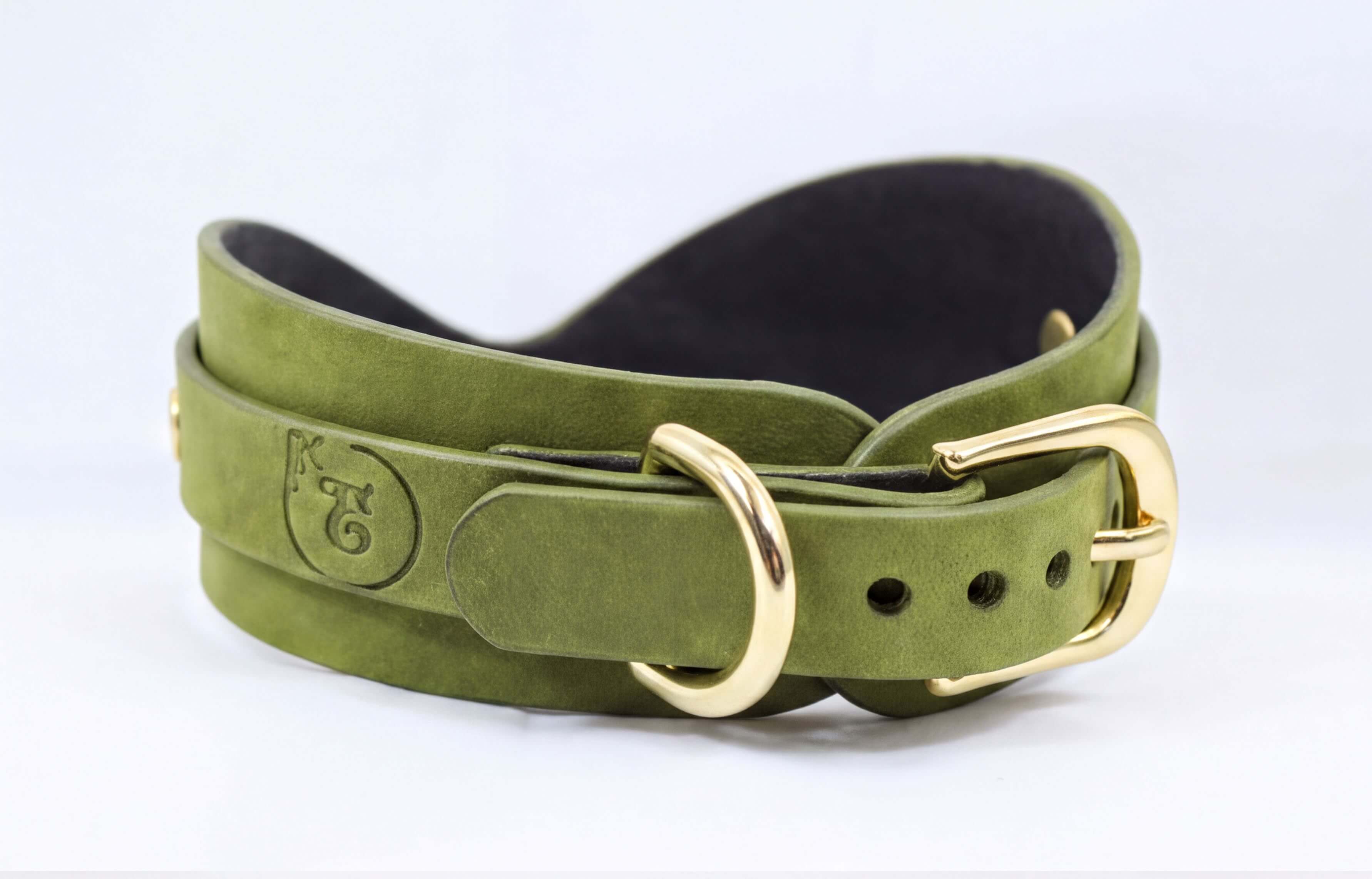 A green leather belt with a gold buckle, featuring a logo on the buckle.