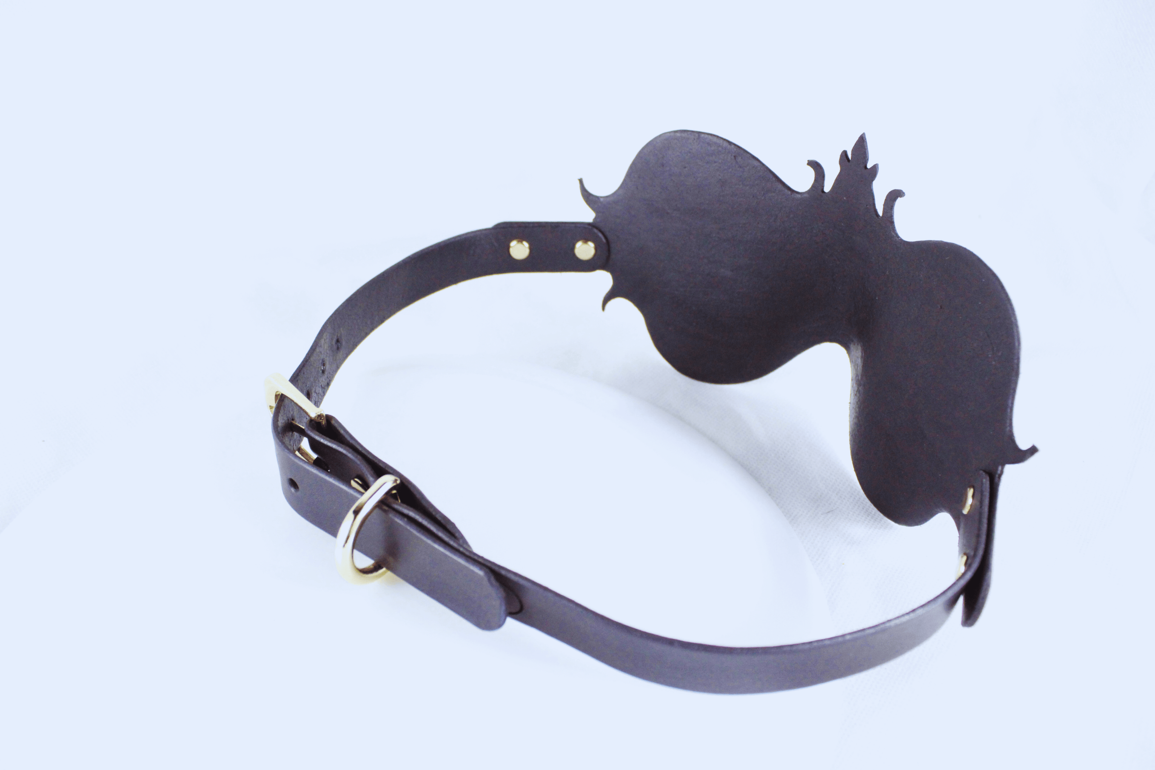 A black leather strap with a decorative design on the end, possibly a headband or accessory.