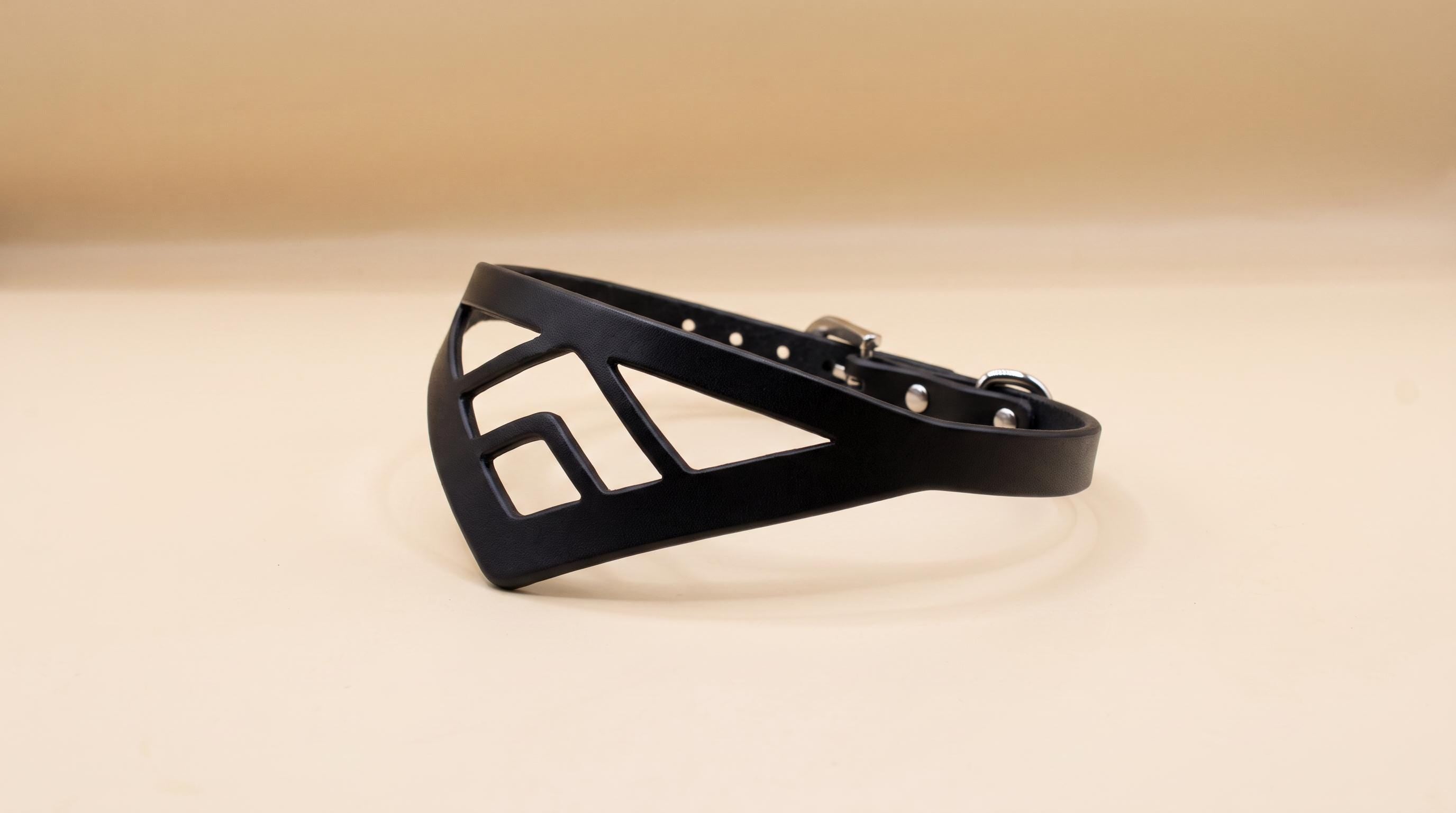 A black leather collar with a geometric pattern on it.