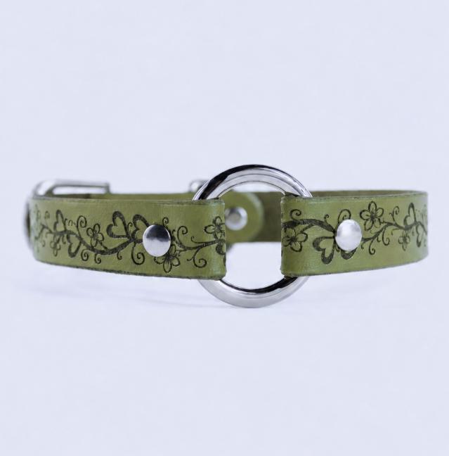 A green leather collar with a floral design and metal ring.