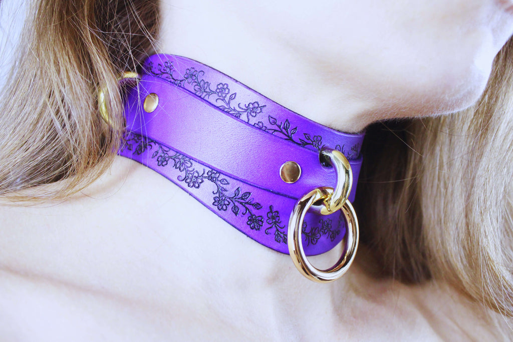 Purple Leather Floral Choker featuring delicate floral motifs and gold rings, showcasing elegance and intimacy.