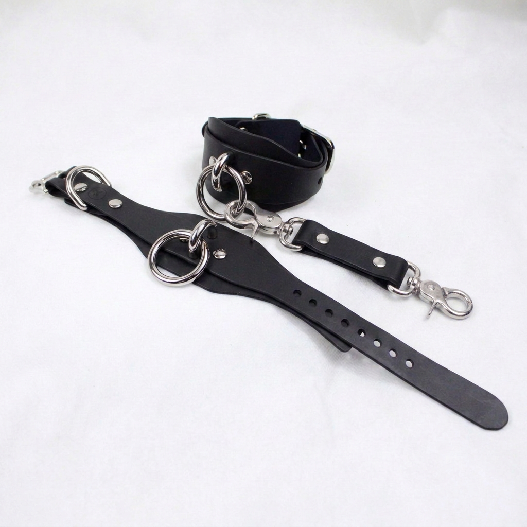 A black leather strap with metal rings and a metal clasp is shown in the image.