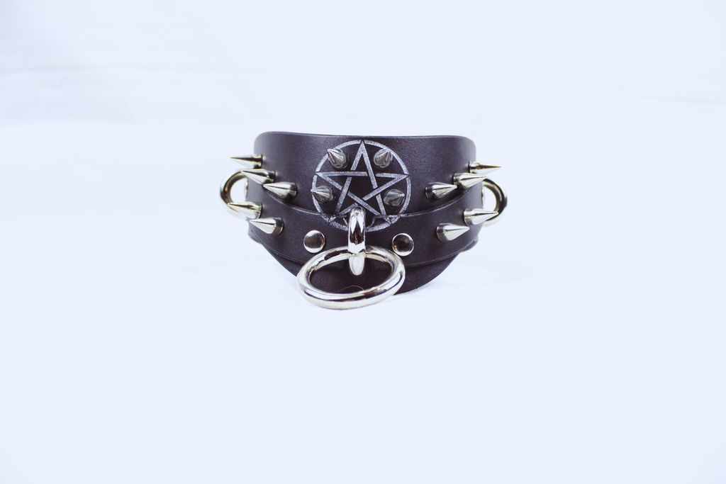 Pentagram BDSM Collar – Spiked posture submissive choker with O-rings and silver pentagram detail.