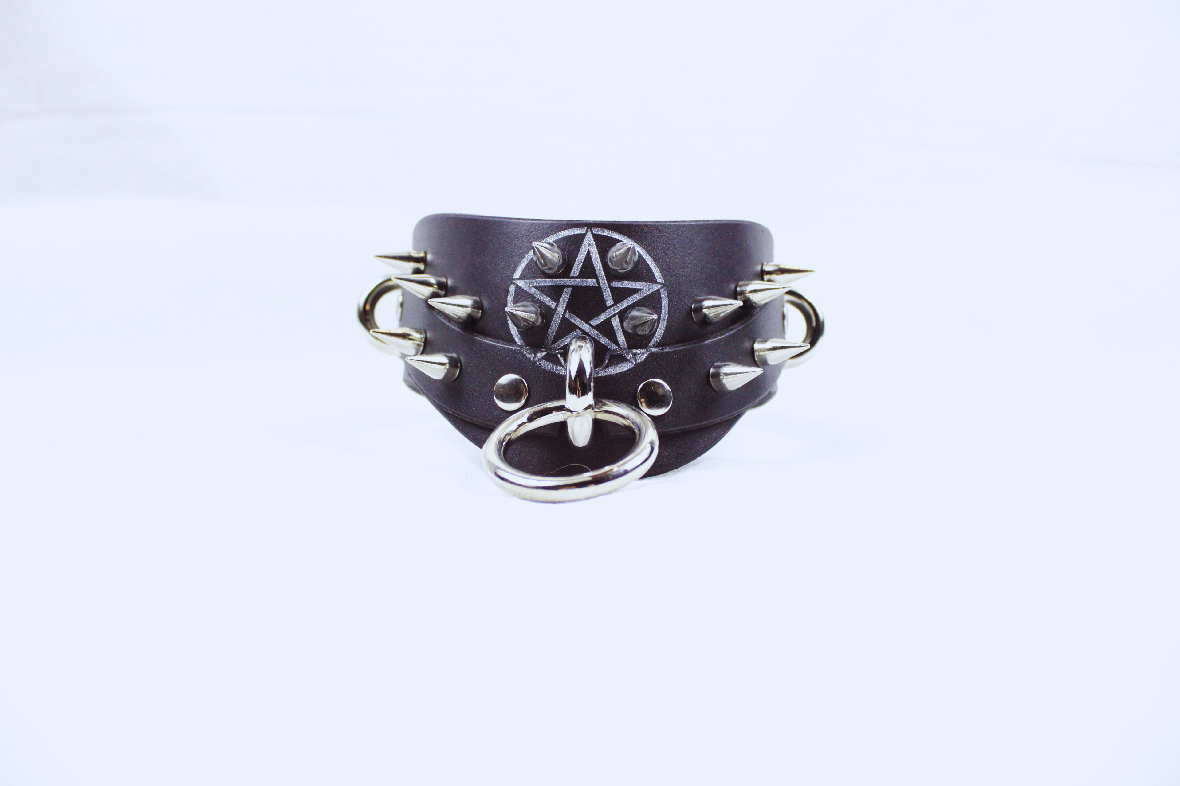 Pentagram BDSM Collar – Spiked posture submissive choker with O-rings and silver pentagram detail.