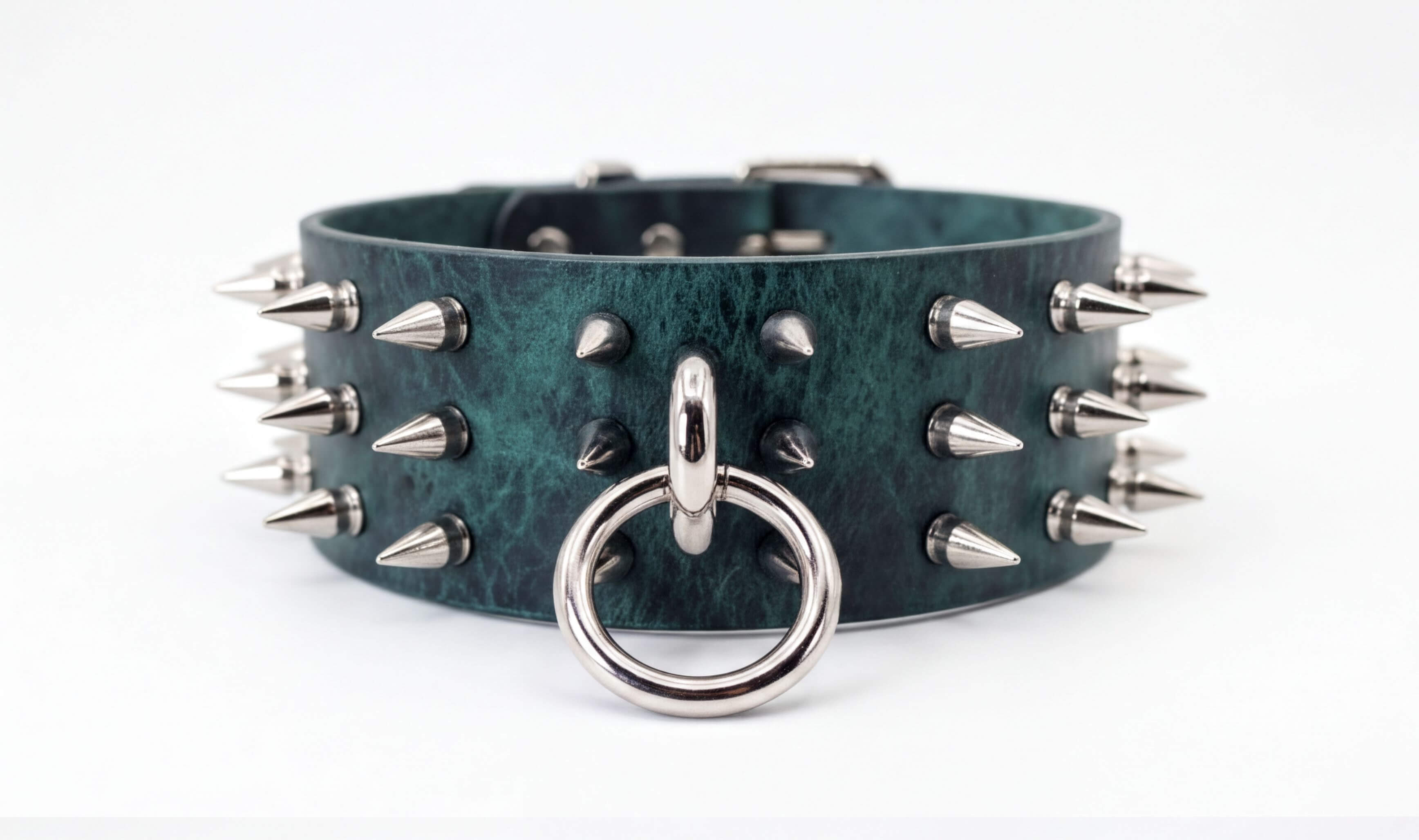 A green leather choker necklace with silver spikes protruding from it.