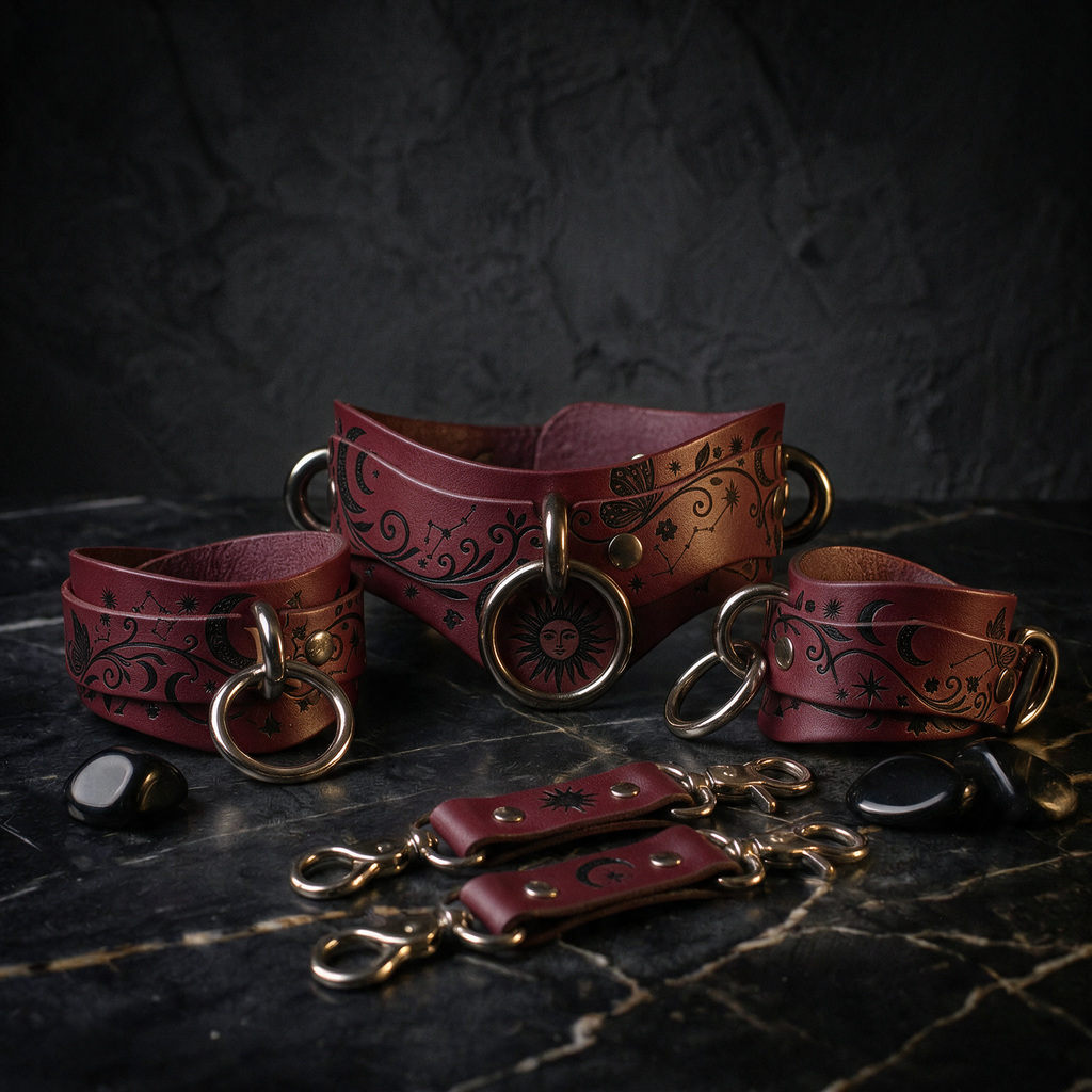 a collection of burgundy leather choker necklaces and straps, each adorned with intricate designs and metal rings, displayed on a dark marble surface.